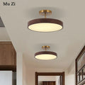 Plafonnier moderne rond imitation bois pour intérieur élégant Aurore Traverse - Une Note Singulière dans le Décor